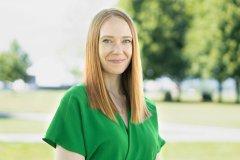 Hannah Barley in green shirt, outside, smiling.